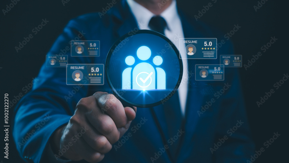 A Human Resources Manager uses a magnifying glass to search and analyze resumes online With the support of CRM systems, recruitment consultants, headhunters, and recruitment agencies, hiring process. A Human Resources Manager uses a magnifying glass to search and analyze resumes online With the support of CRM systems, recruitment consultants, headhunters, and recruitment agencies, hiring process.