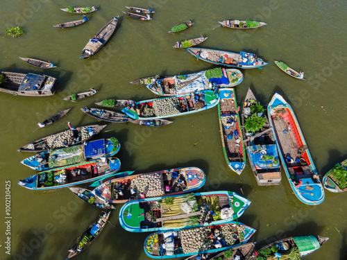 Aerial view of traders selling fruits and vegetables from boats at Boithakata floating market on Belua river, Boithakata, Pirojpur district, Bangladesh. photo