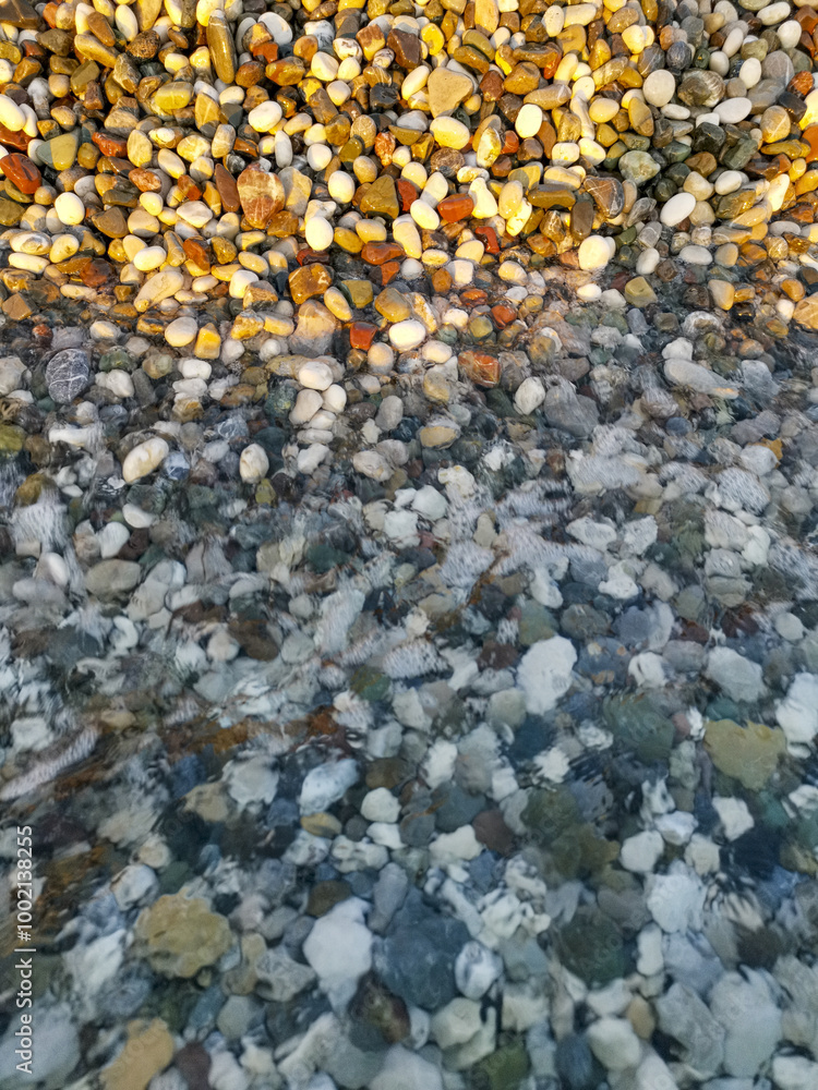 Rocky shoreline with a body of water in the background Rocky shoreline with a body of water in the background