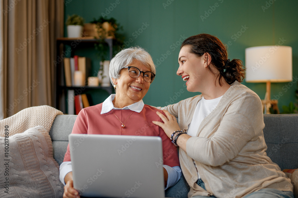 Young and senior women are using laptop Young and senior women are using laptop