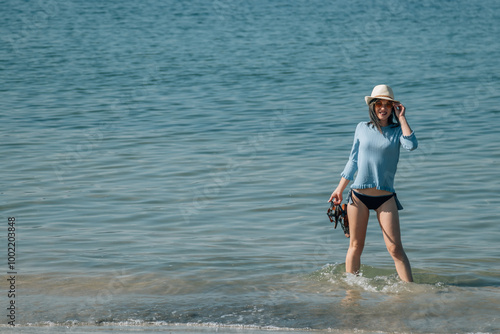 Woman enjoying on the beach relaxed and happy