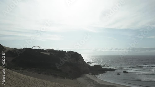 Paragliding Activity At Cape Kiwanda On Pacific Coast In Oregon, USA. tracking drone shot photo