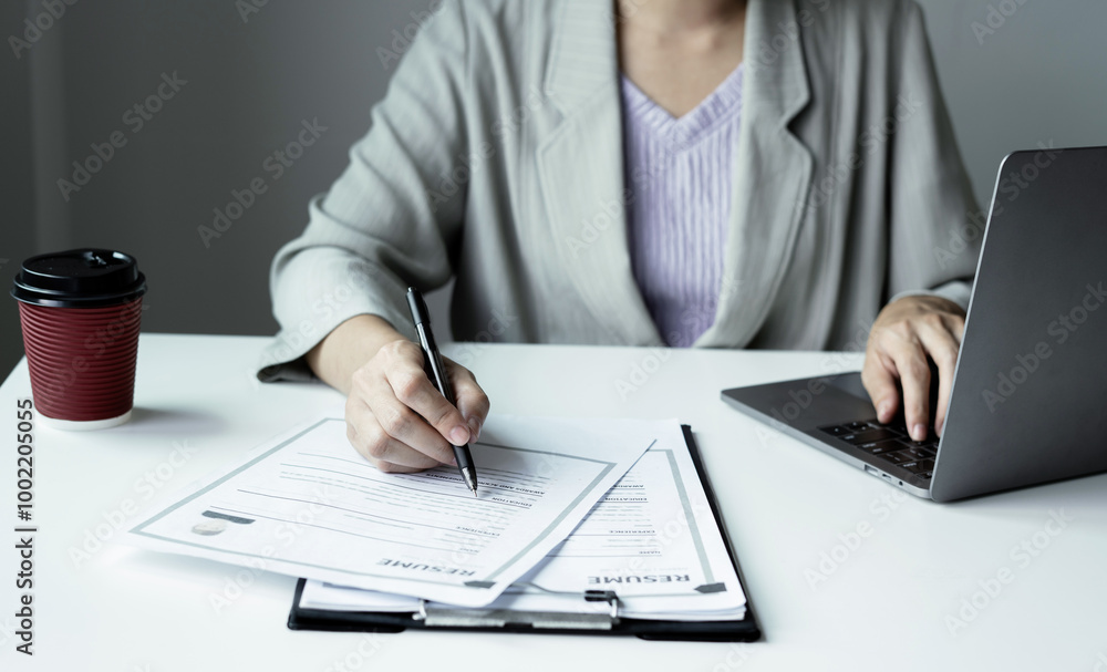 Business woman employer holding resume hiring recruit looking cv resume to hire candidates, analyzing information before job interview. Recruitment concepts Business woman employer holding resume hiring recruit looking cv resume to hire candidates, analyzing information before job interview. Recruitment concepts