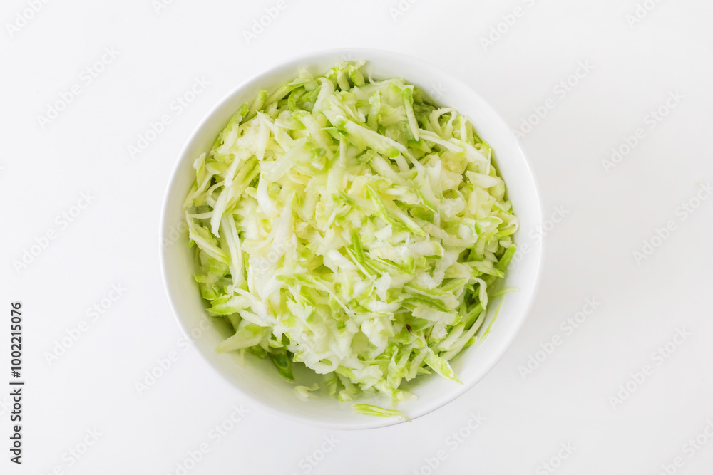 A bowl of freshly shredded white and green cabbage, perfect for healthy salads or coleslaw recipes, ideal for summer picnics A bowl of freshly shredded white and green cabbage, perfect for healthy salads or coleslaw recipes, ideal for summer picnics