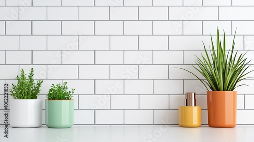 Stylish potted plants in modern containers set against a clean white tiled wall, creating a fresh and vibrant atmosphere for interior decor.