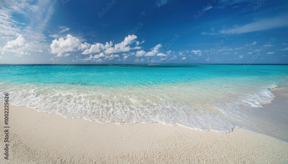 Beautiful sandy beach with white sand and rolling calm wave of turquoise ocean on Sunny day Beautiful sandy beach with white sand and rolling calm wave of turquoise ocean on Sunny day