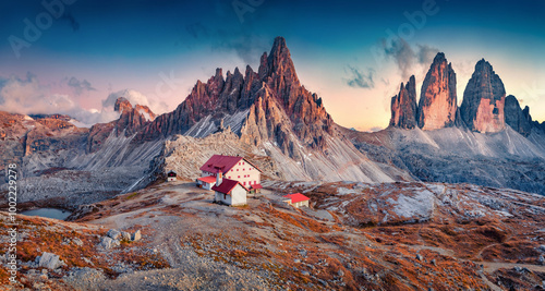 Breathtaking autumn scenery. Superb sunrise in Tre Cime Di Lavaredo National park with Paternkofel Peak. Spectacular morning scene of Dolomite Alps, Italy, Europe. Traveling concept background. photo