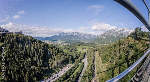 A panoramic view from Highline 179 suspension bridge in Tirol, Austria, showcasing the valley, forests, and snow-capped mountains under a clear sky.. photo