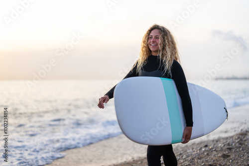 Photography Portrait of a young happy woman, surfing and enjoying summer vacation on the bea