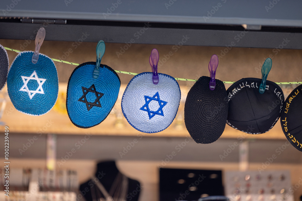 Prague, Czech Republic - September 4, 2024: Colorful handmade Jewish caps with Star of David, Kippah, sold in the street shop before entering the Klausen Synagogue in Josefov district