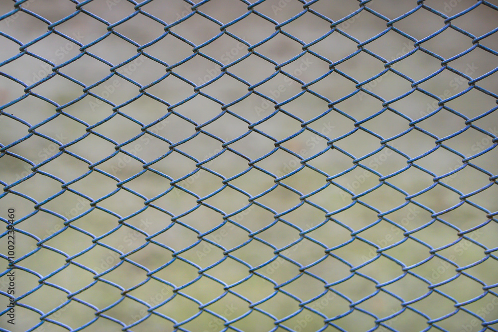 Chain link fence stands out against a softly blurred background symbolizing boundaries separation Chain link fence stands out against a softly blurred background symbolizing boundaries separation
