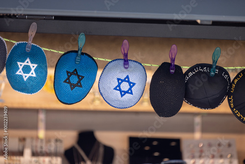 Obraz na płótnie Prague, Czech Republic - September 4, 2024: Colorful handmade Jewish caps with Star of David, Kippah, sold in the street shop before entering the Klausen Synagogue in Josefov district w salonie