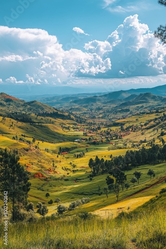 Lush green valley with rolling hills and clouds under a bright blue sky in th...