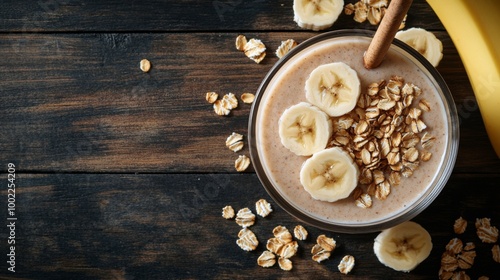 Banana smoothie with oats and honey on a wooden table