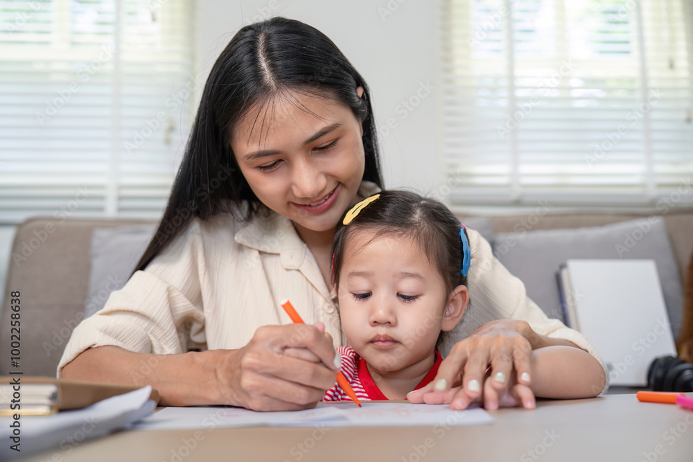 Caring Mother Assisting Daughter with Drawing Activity Caring Mother Assisting Daughter with Drawing Activity