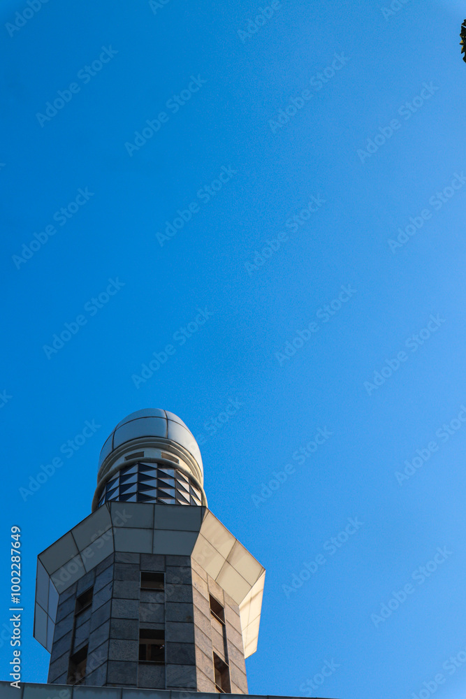 Obraz premium A close-up photo of a mosque minaret against a clear blue sky, Islamic Concept, Religious