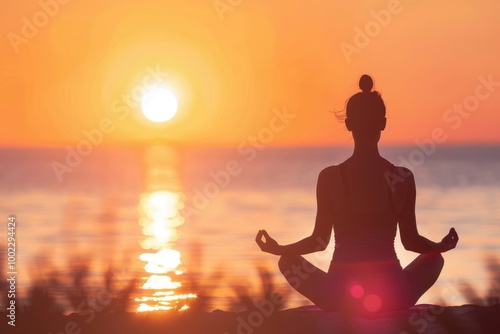 Woman finding freedom in nature during sunrise meditation. photo