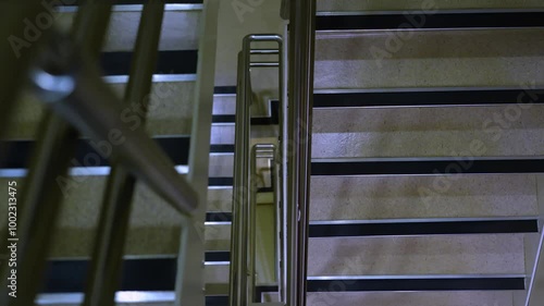 The iron staircase is seen from above. The abstract steps