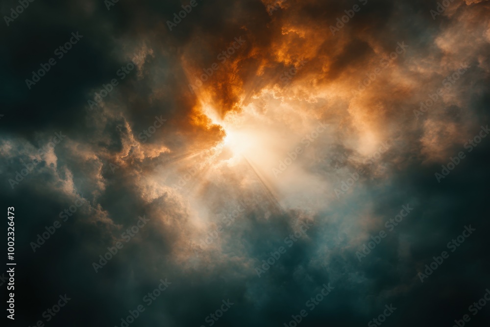 Light beams breaking through dark clouds in a dramatic sky