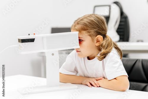 A young girl engages in orthoptic and pleoptic therapy using advanced vision stimulation equipment. Laser eye treatment promotes recovery and enhances vision in a soothing environment. photo