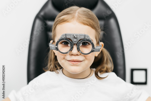 A doctor diagnosing a little girl’s vision and selecting lenses using a modern medical device. Perfect for illustrating diagnostics and vision correction.