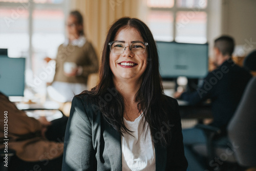 Portrait of happy entrepreneur wearing eyeglasses in office photo