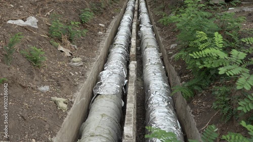 Underground heat pipes. Replacement of heat communications pipeline in the city. Large diameter pipes for heating. High quality 4k footage