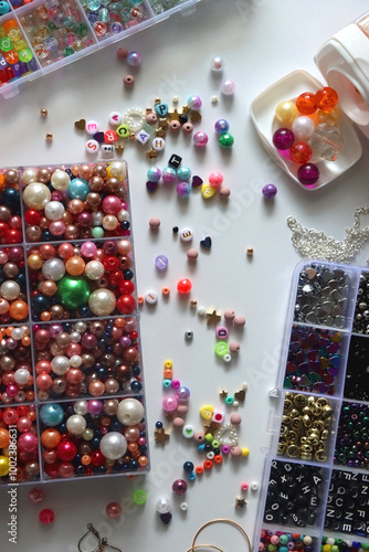 Obraz na płótnie Colorful beads, letter beads, threads and other jewelry making supplies on white background. Making friendship bracelets concept. Flat lay. w salonie