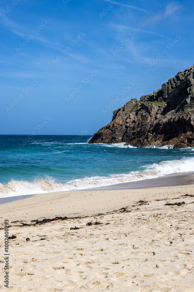 The rugged Cornish coastline at Portheras Cove, with a blue sky overhead The rugged Cornish coastline at Portheras Cove, with a blue sky overhead