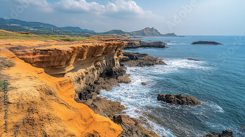 Natural stone formations along the coast of Yehliu Geopark with the ocean waves crashing nearby photo