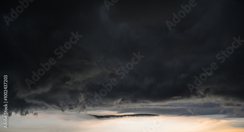 Dramatic sunset sky with dark clouds.