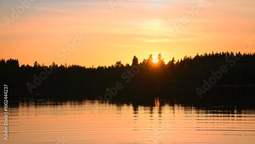 Sunset with warm colors on a Swedish lake in Smalland. Romantic evening atmosphere