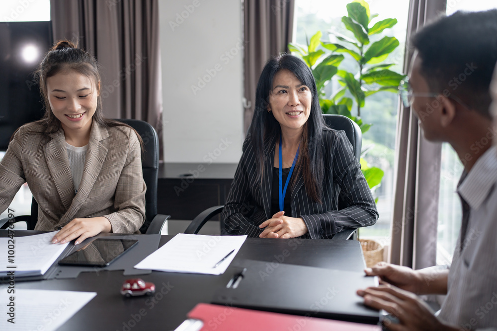 Sales manager giving advice application form document, considering mortgage loan offer for car and house insurance. Sales manager giving advice application form document, considering mortgage loan offer for car and house insurance.
