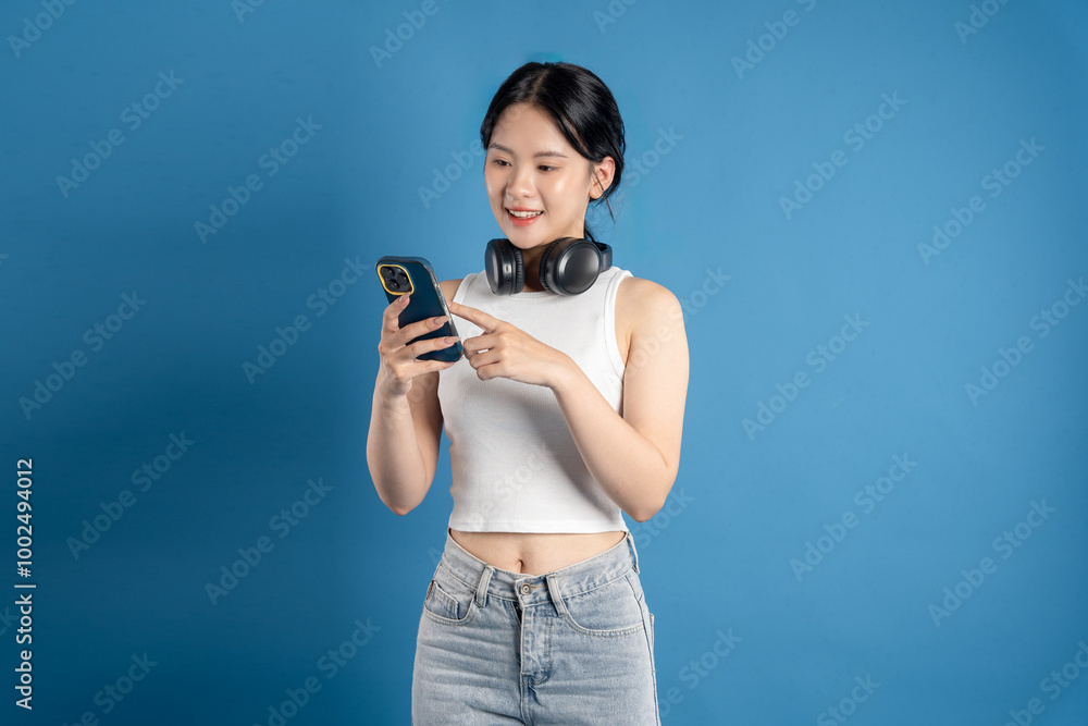 Portrait of beautiful Asian woman posing on blue background. Portrait of beautiful Asian woman posing on blue background.