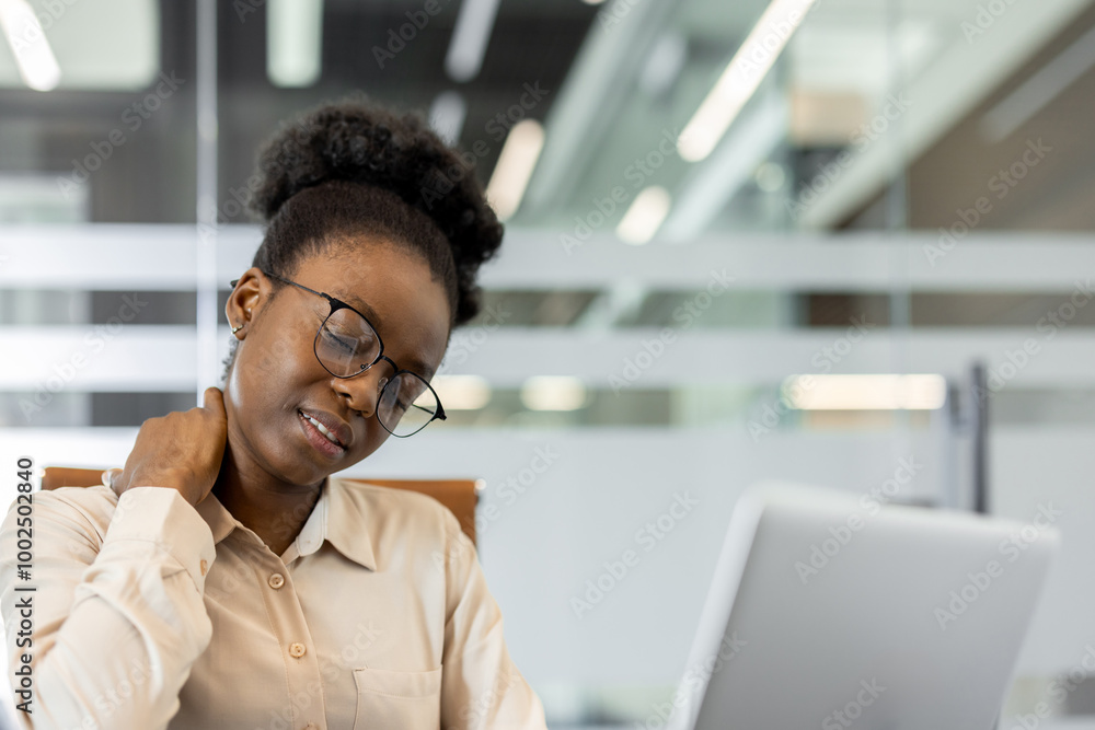 Office worker appears stressed and uncomfortable, suffering neck pain while using laptop. Scene conveys work stress, discomfort, and need for ergonomic awareness in workplace. Office worker appears stressed and uncomfortable, suffering neck pain while using laptop. Scene conveys work stress, discomfort, and need for ergonomic awareness in workplace.