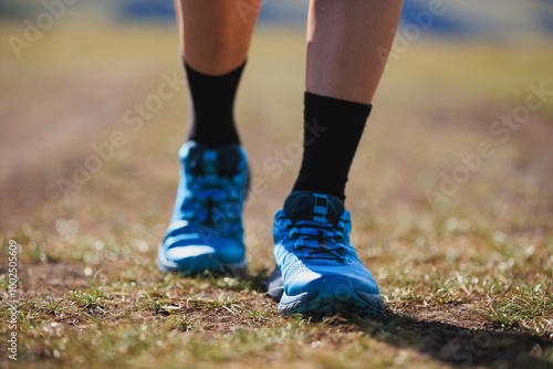 Fitness woman runner running at high altitude grassland mountain top road