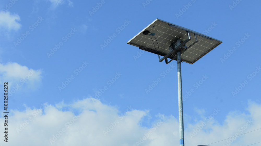 Solar panels on street light poles with blue sky background Solar panels on street light poles with blue sky background