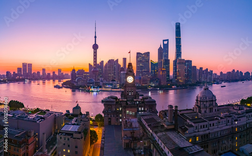 Aerial view of modern city skyline and buildings at sunrise in Shanghai