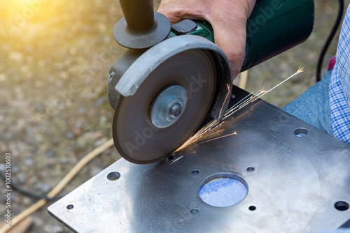 Cutting metal with a grinder. Processing and grinding of metal with sparks photo