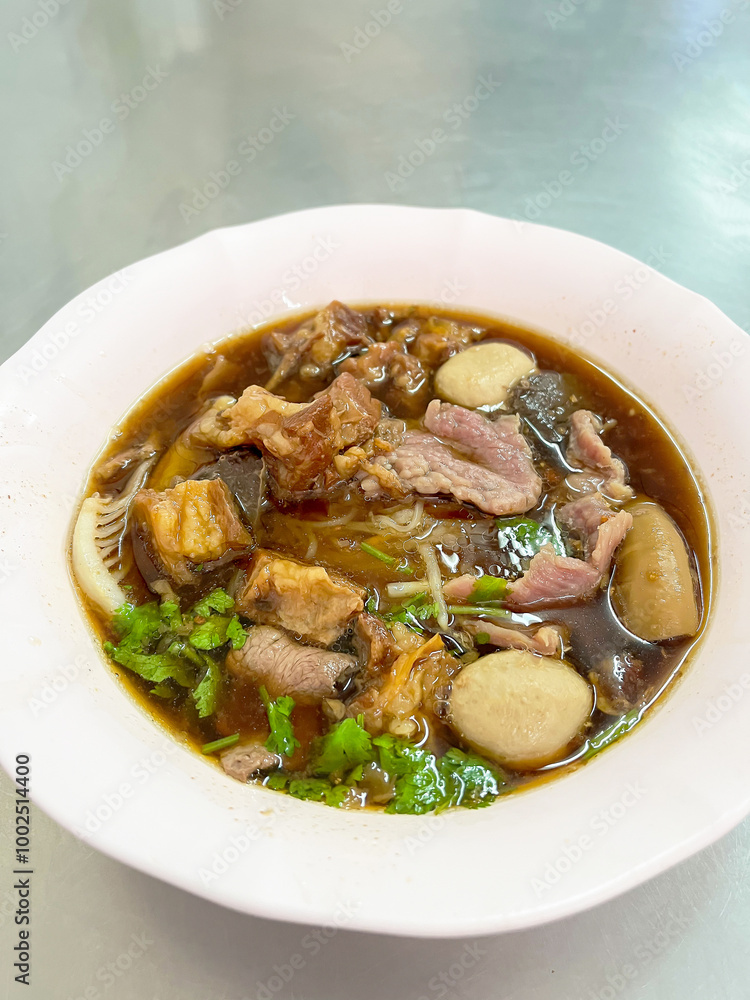 A delicious bowl of savory meat soup with herbs and vegetables, perfect for comfort food lovers and food enthusiasts. A delicious bowl of savory meat soup with herbs and vegetables, perfect for comfort food lovers and food enthusiasts.