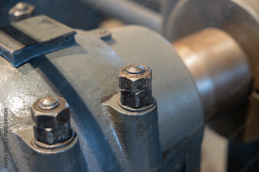 Old pipeline with a flange and screws, connected to a pump. Mechanical connection, pipeline, industrial design, old machine. Old pipeline with a flange and screws, connected to a pump. Mechanical connection, pipeline, industrial design, old machine.