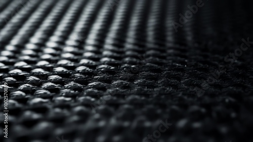 Close-up of a textured black surface showcasing a unique pattern and depth, ideal for backgrounds or design elements.