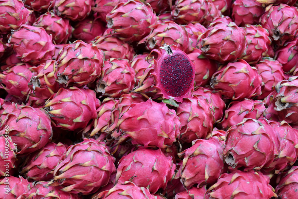 Vibrant ripe dragon fruit piled together for sale at a flea market Vibrant ripe dragon fruit piled together for sale at a flea market