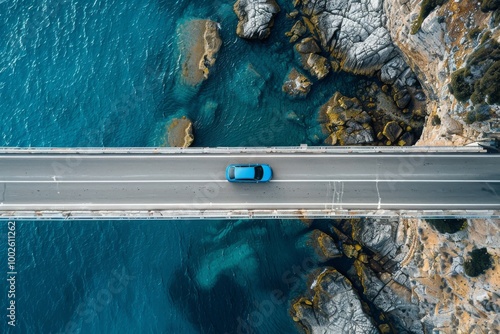 Fototapeta Naklejka Na Ścianę i Meble -  Aerial drone top view of blue car driving on bridge asphalt road above the sea or ocean water coast. Summer tourism travel and transportation landscape, trip, rock, cliff