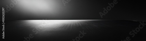 A Single Light Source Illuminating a Smooth, Black Surface