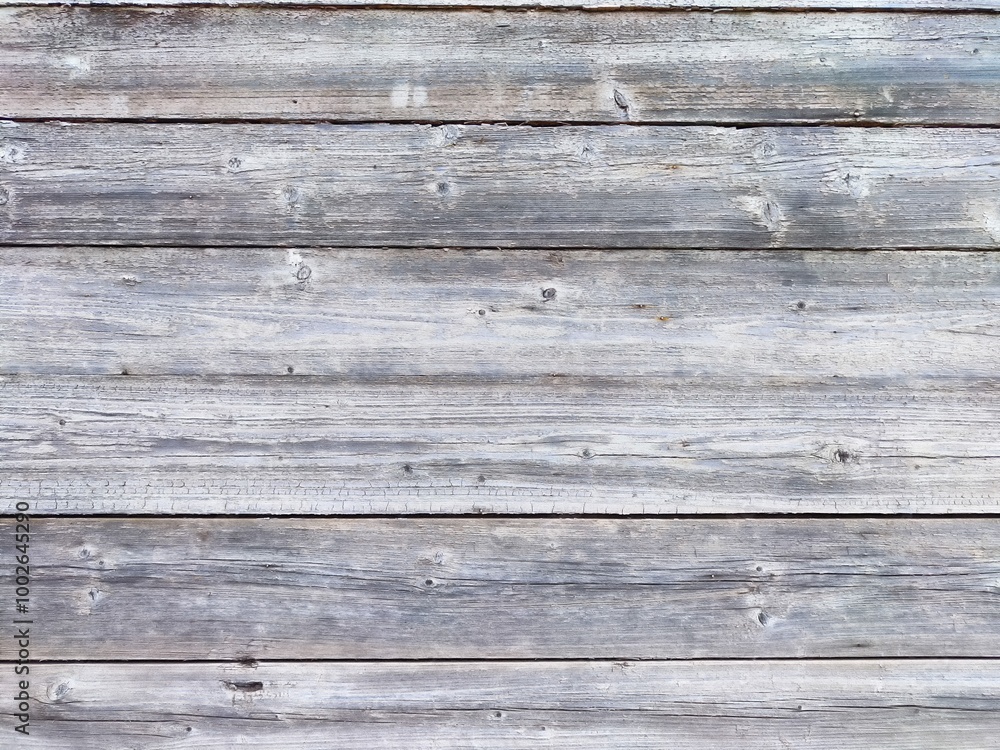 Weathered wooden planks in a rustic setting during bright daylight Weathered wooden planks in a rustic setting during bright daylight