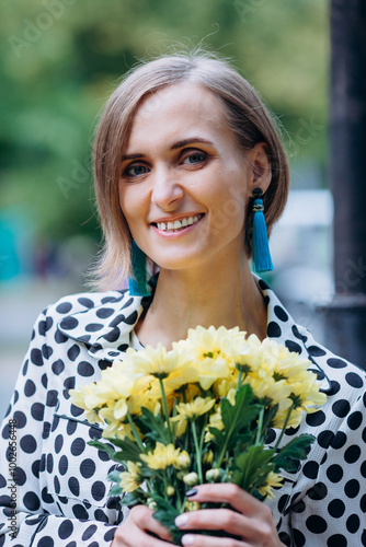 Wallpaper Mural A woman in a polka dot dress holds a bouquet of yellow flowers. Torontodigital.ca