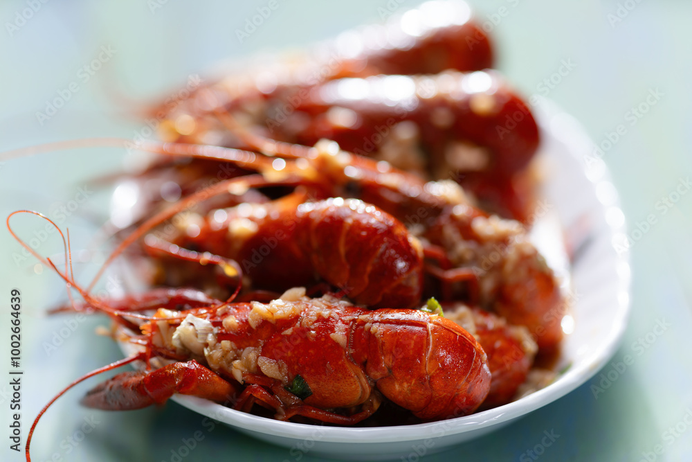 plate of traditional garlicky spicy sichuan red crawfish