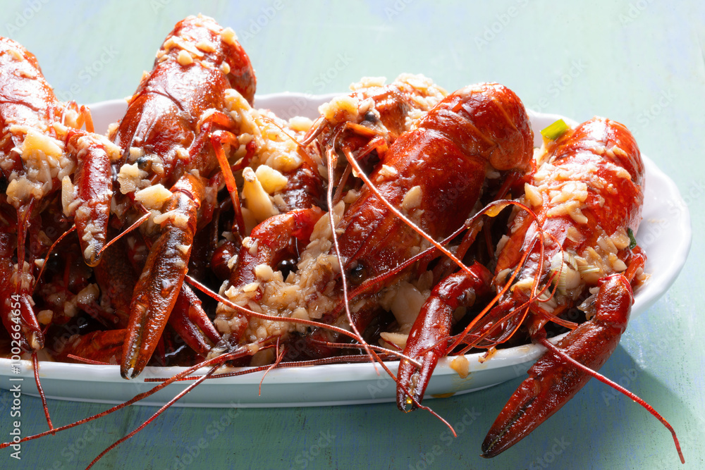 plate of traditional garlicky spicy sichuan red crawfish