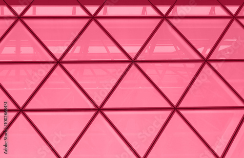 Obraz na płótnie Office building facade with triangular windows, modern skyscraper toned into magenta color. Horizontal abstract background, image with place for text. Inspired by Pantone color of the year 2023. w salonie